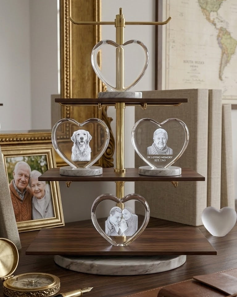 Decorative display with heart-shaped crystal figures on a wooden stand, surrounded by framed photos and a world map.
